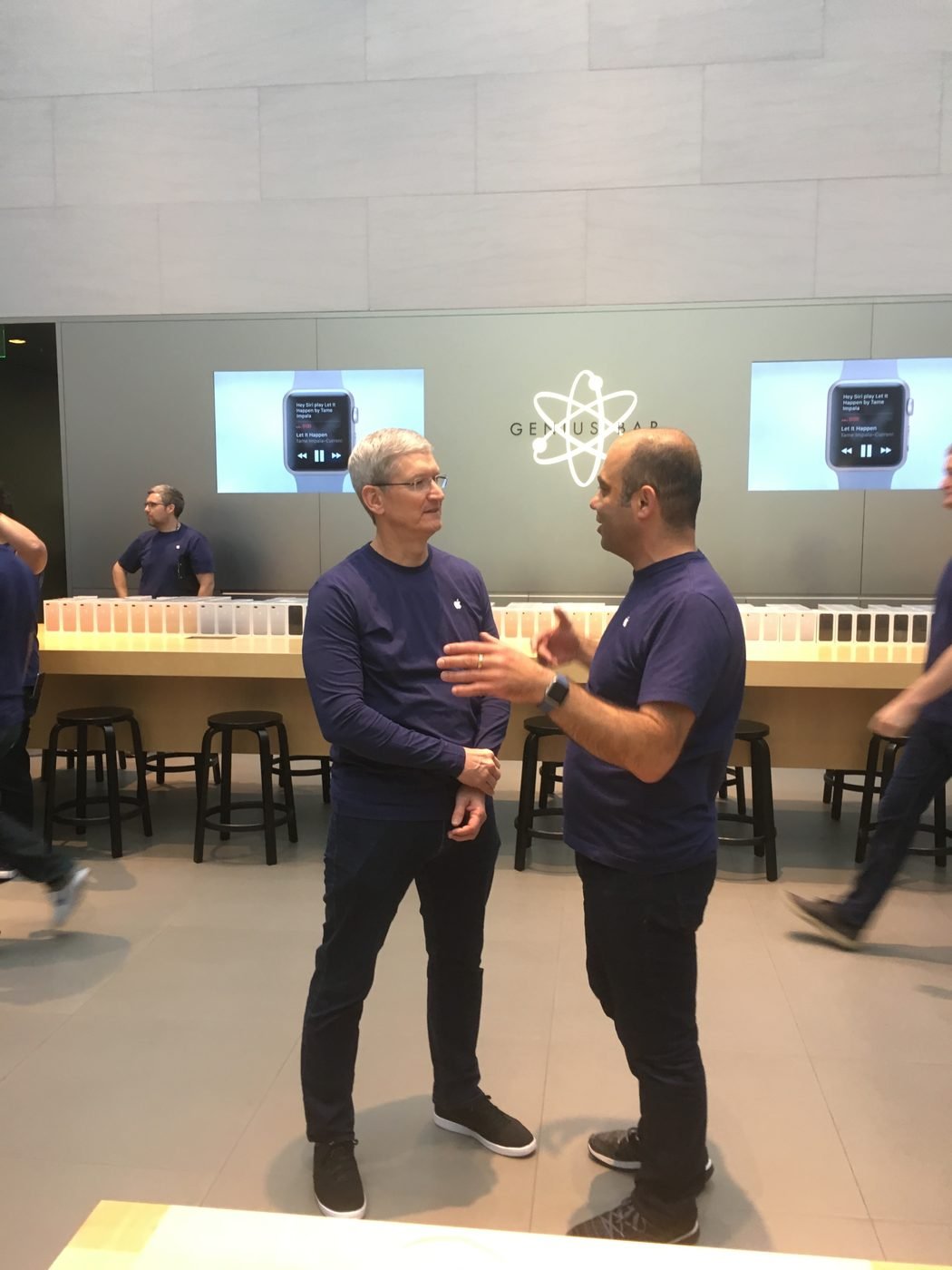 Tim Cook and Baha Cinar in conversation at the Genius Bar, Apple Watch on the screens behind them